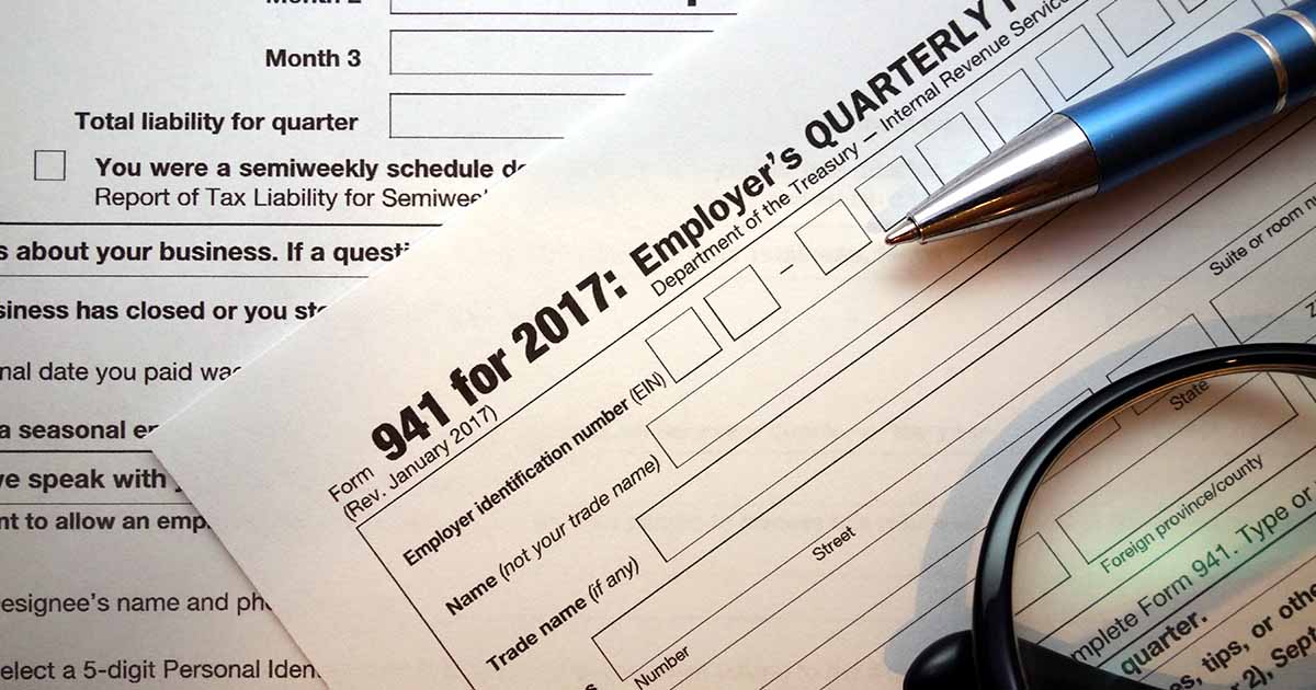 Tax Form 941 paper with a pen.
