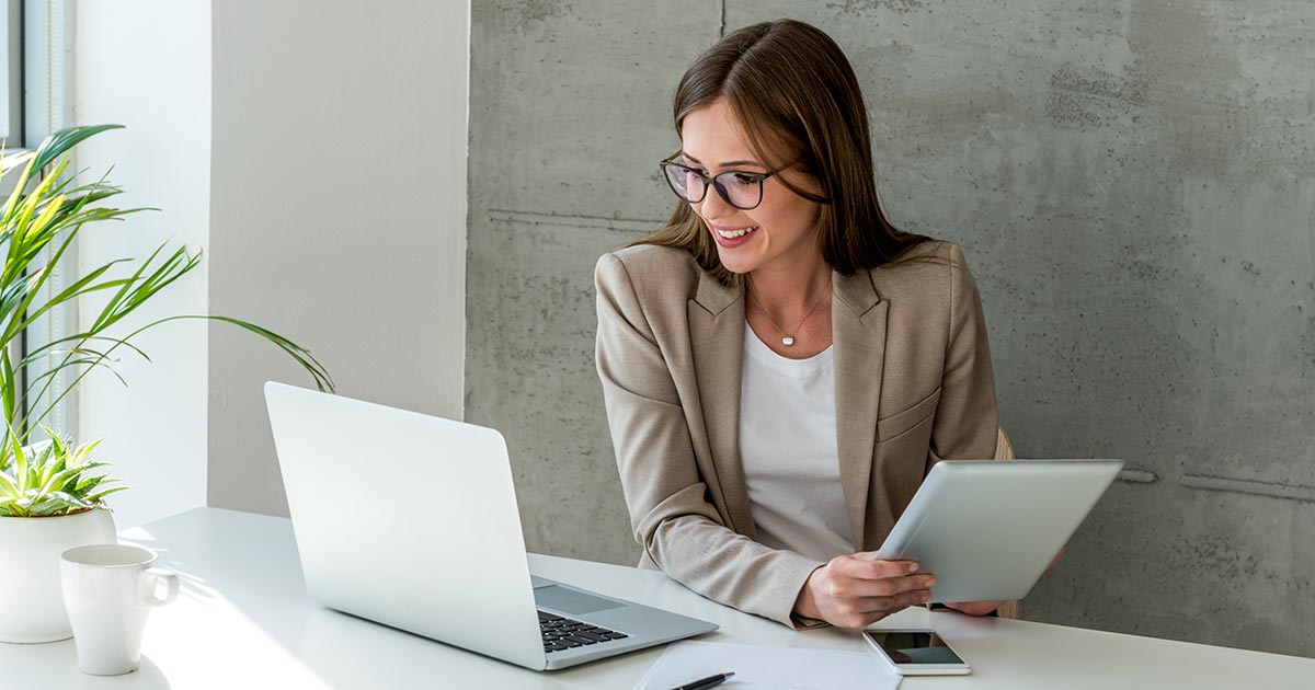 Woman with laptop and iPad.