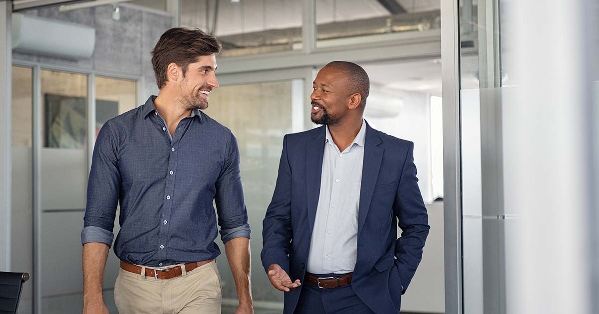 Two businessmen talking to each other.