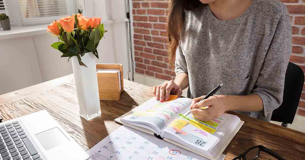 Woman in front of a calendar.