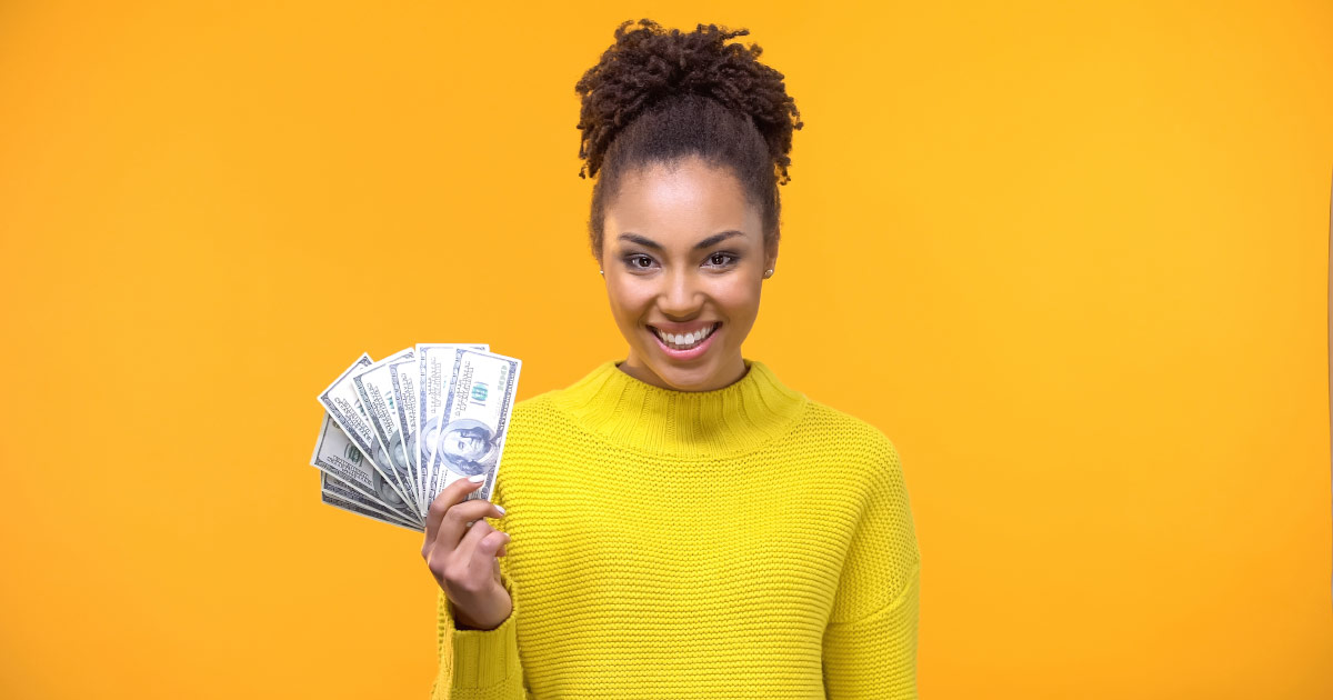 Woman in business holding money.